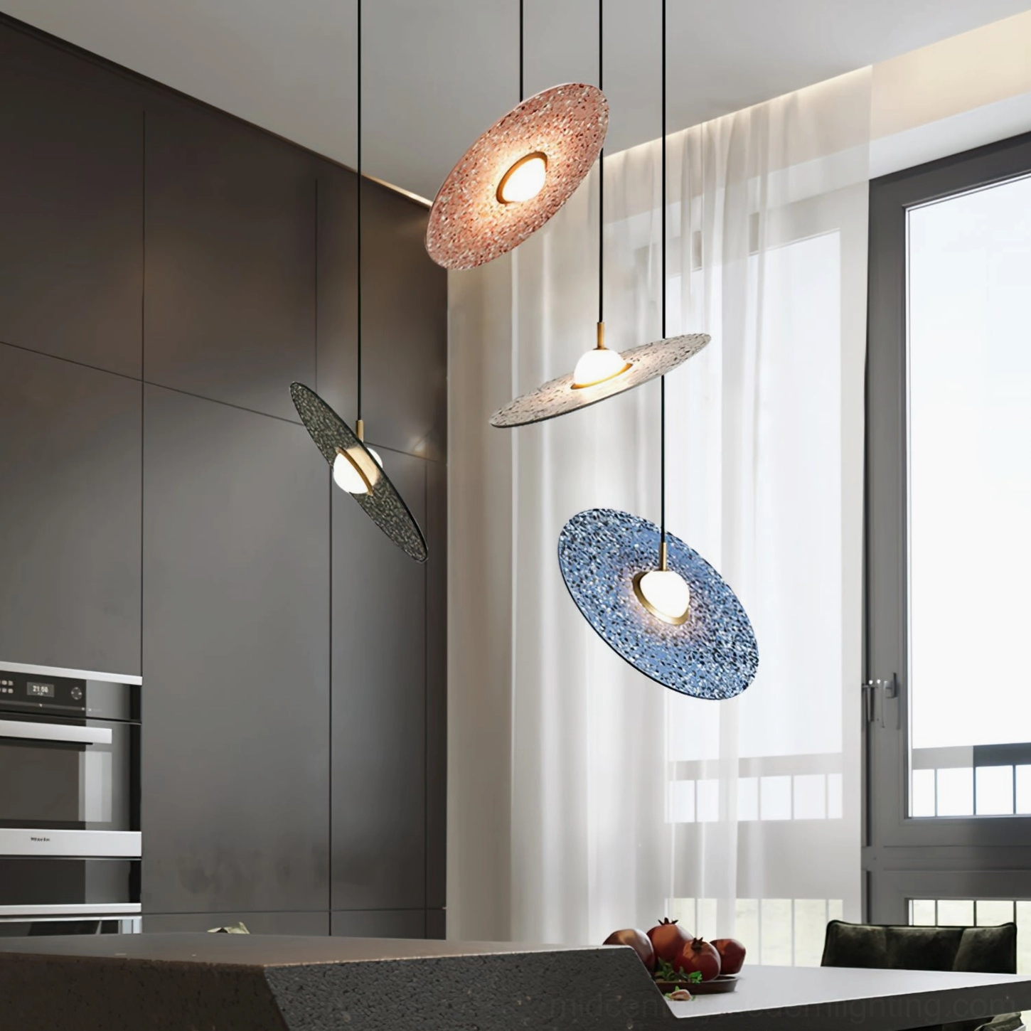 Staggered mixed terrazzo pendant lamps in dark modern kitchen creating warm ambient lighting