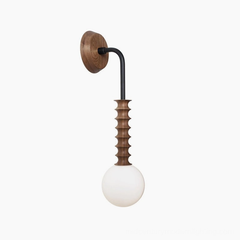 Mobo wall sconce featuring black metal arm and walnut wood backplate in side profile on white studio backdrop