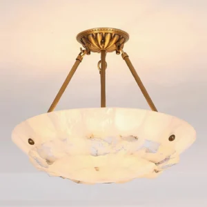 Mid-century modern alabaster pendant light at eye level displaying warm diffused glow and brass hardware