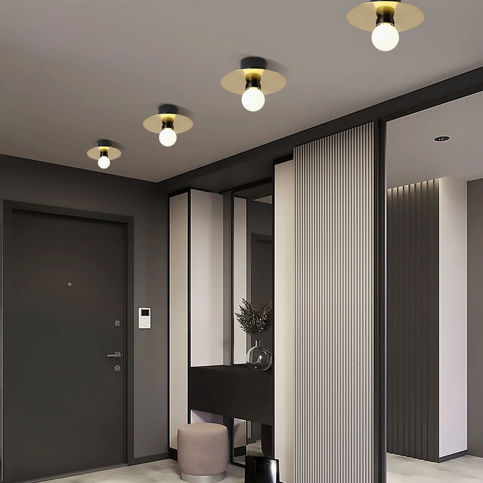 Warm brass frosted glass ceiling lights in contemporary apartment hallway corridor