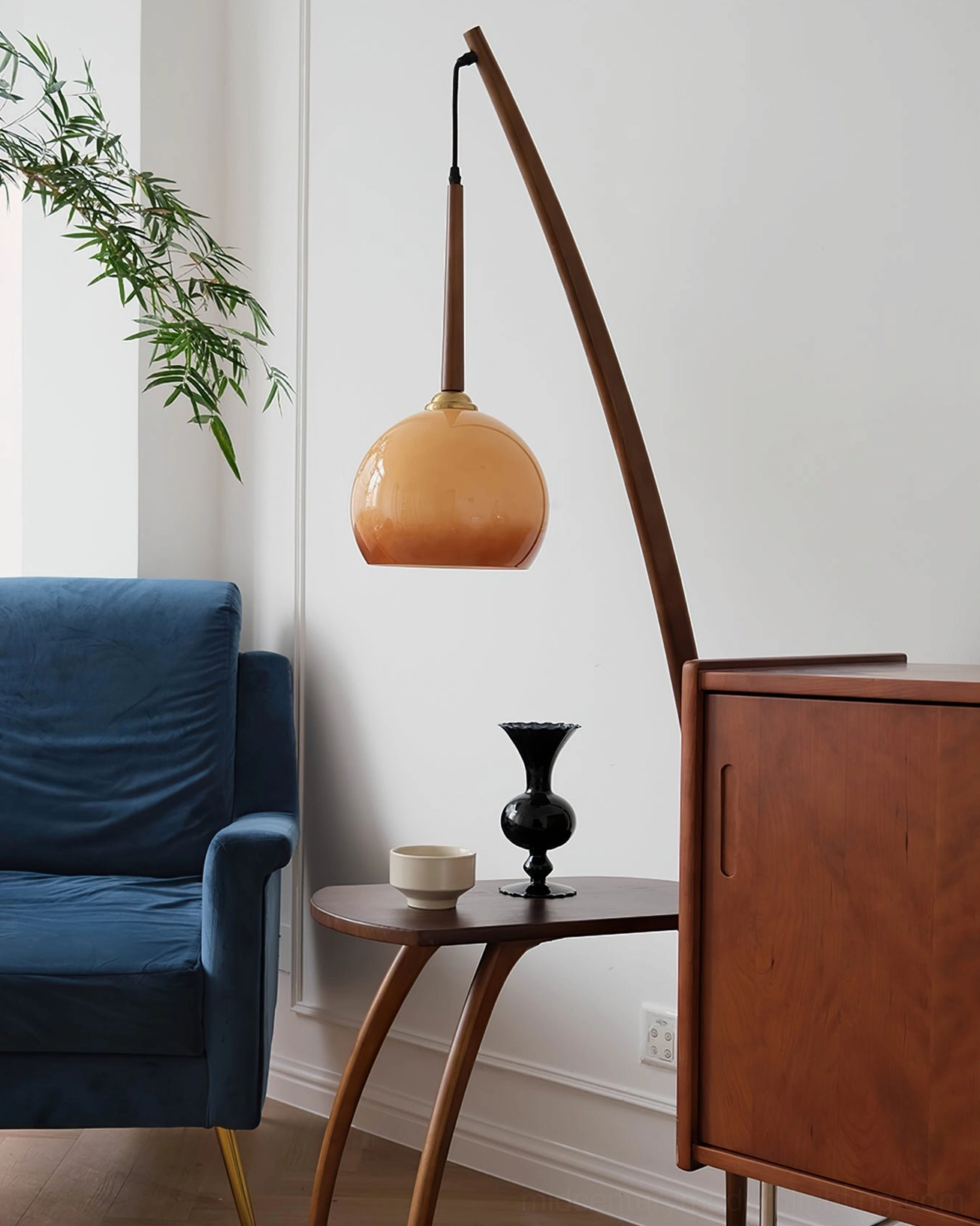 Modern arc lamp with side table in blue sofa living room, compact walnut and brass design