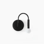 Modern arch wall sconce with matte black metal frame and frosted glass globe, front view on white background