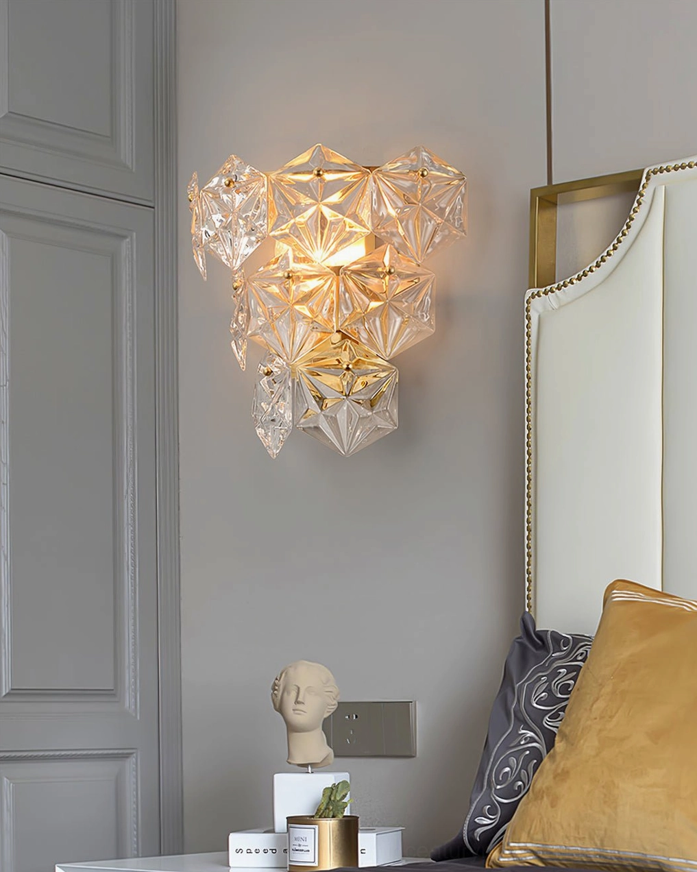 Contemporary crystal wall lamp installed as bedroom accent with coordinated luxury interior decor