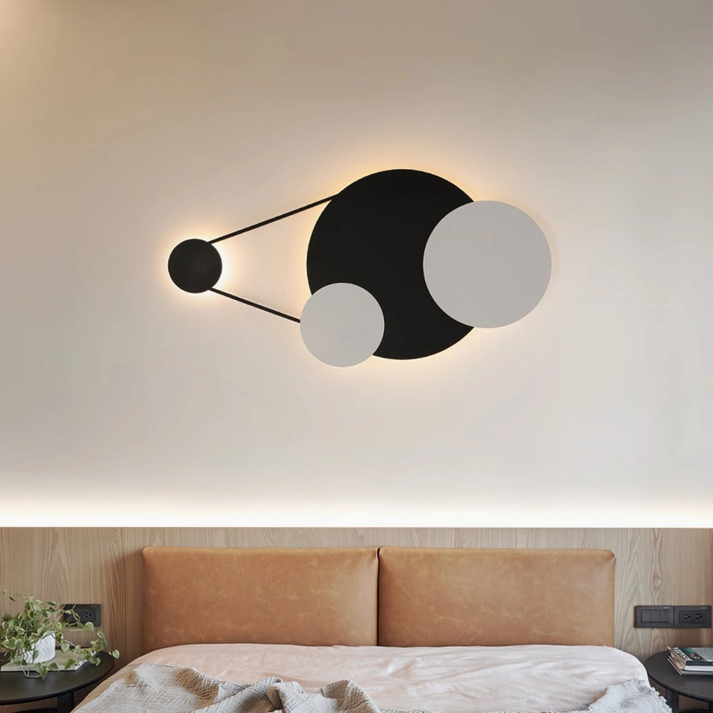 Contemporary bedroom with Vertical Trio wall lamp above leather bed frame providing cozy indirect lighting
