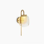 Satin brass wall sconce with frosted amber glass shade on white background - modern mid-century design