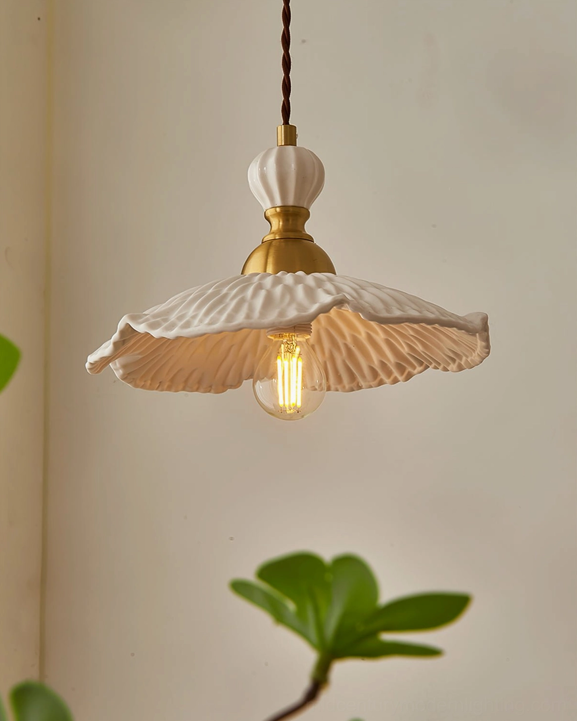 Modern artisan ceramic pendant light with clean geometric profile and brass hardware