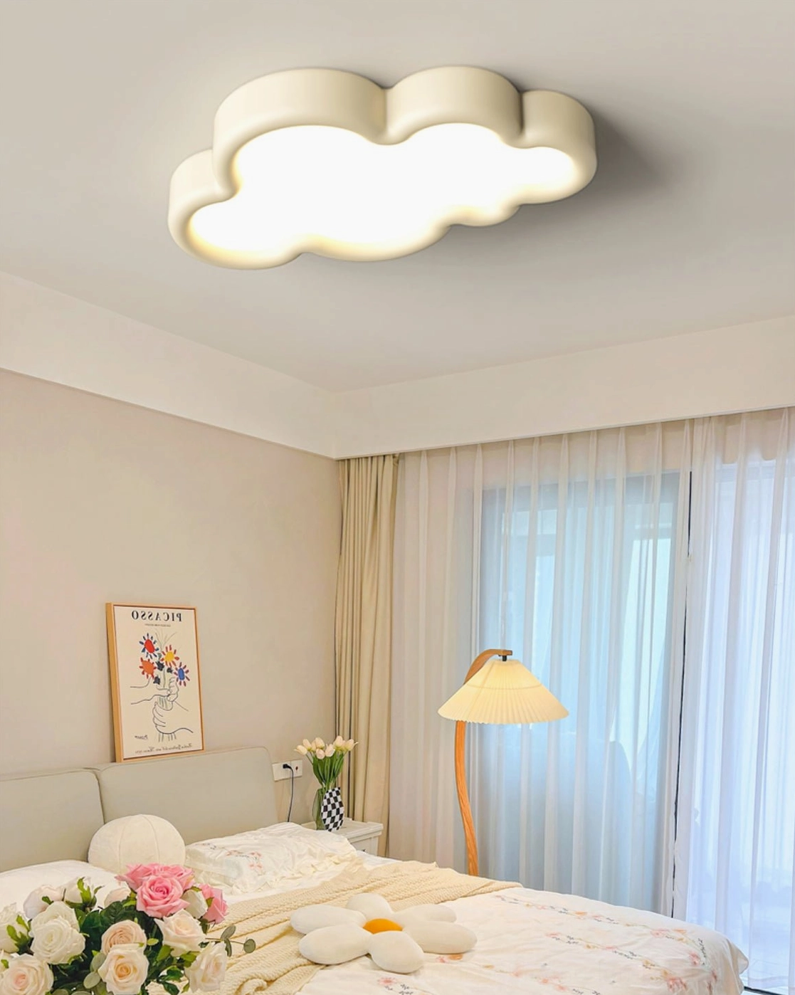 Illuminated cloud ceiling light with soft warm glow in beige minimalist bedroom