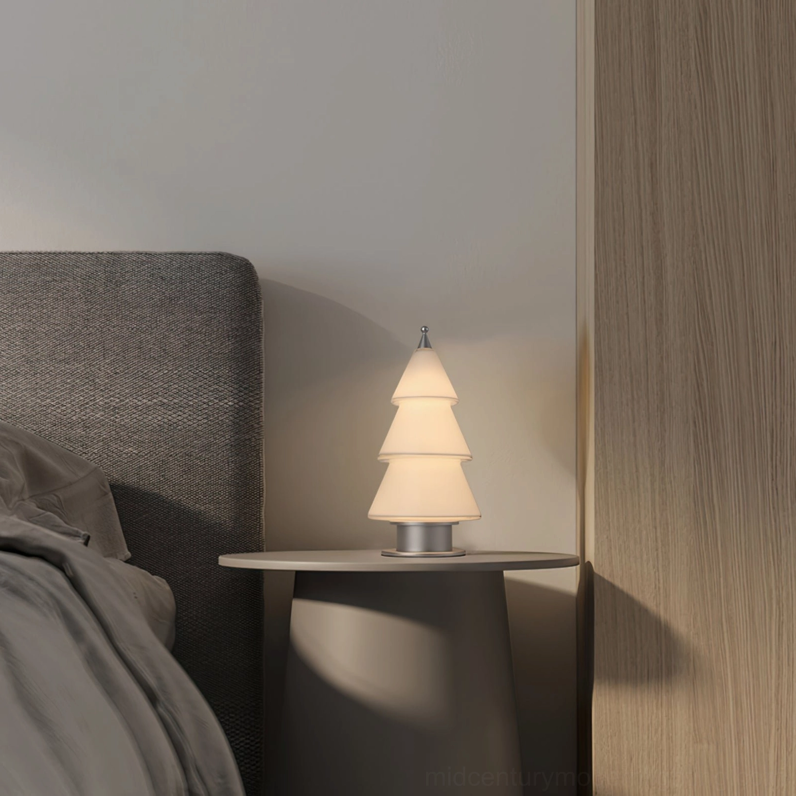Contemporary tiered cone table lamp with warm LED lighting on bedroom corner table with modern Nordic décor