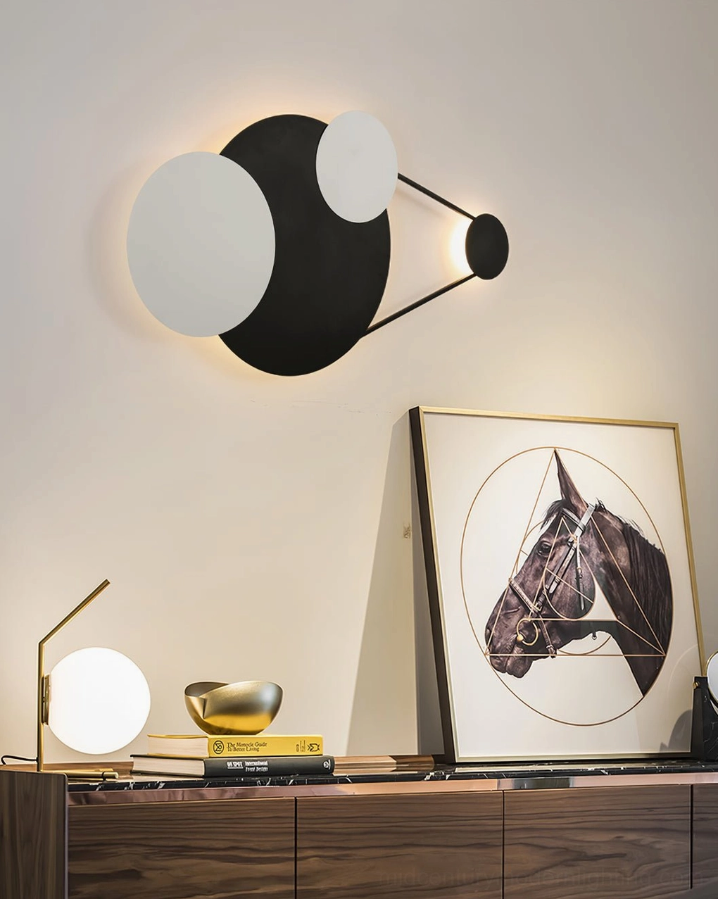 Modern console table area with Vertical Trio wall lamp and matching table lamp, wooden furniture and wall art