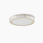 Modern round crystal flush mount ceiling light with gold stainless steel frame, studio close-up view