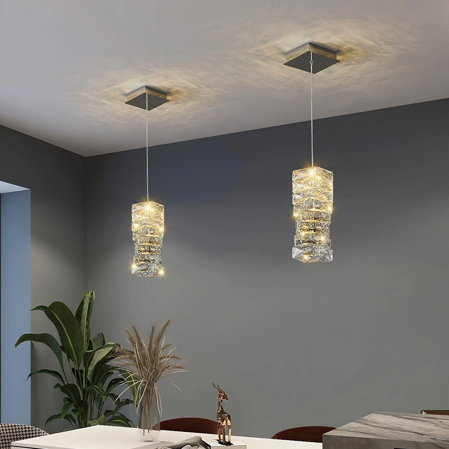 Multiple faceted crystal pendant lights installed in modern dining room with square ceiling mounts and warm ambient lighting