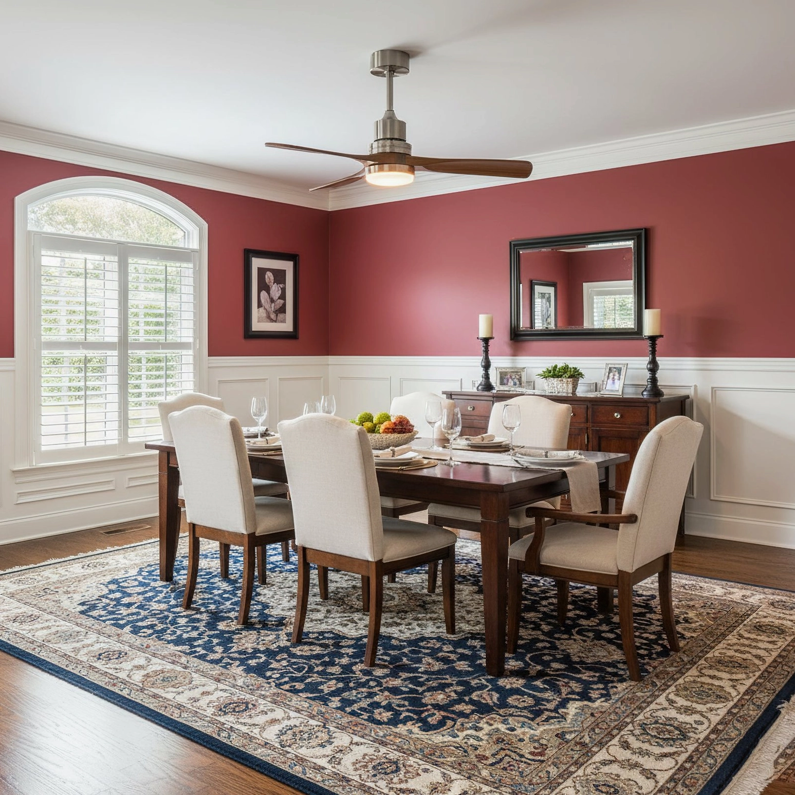 Modern fan light with three-color LED in contemporary dining room with burgundy accent wall and decorative mirror wall art