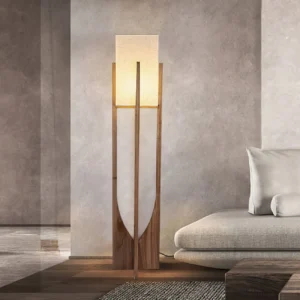 Mid-century modern floor lamp with natural wood base positioned in contemporary living room with concrete wall and sofa
