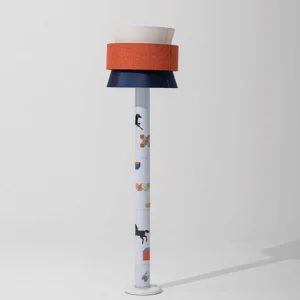 Modern playful standing lamp with tri-color shade, angled view showing woven fabric detail and printed decorative pole