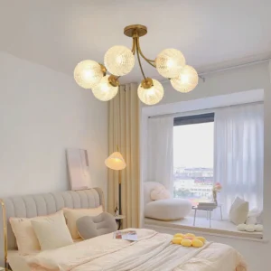 Mid-century modern 8-head glass chandelier installed in cream bedroom with warm ambient lighting and textured glass orbs