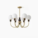 Modern glass pendant chandelier with brass metal frame and frosted white spherical shades, front view on white background