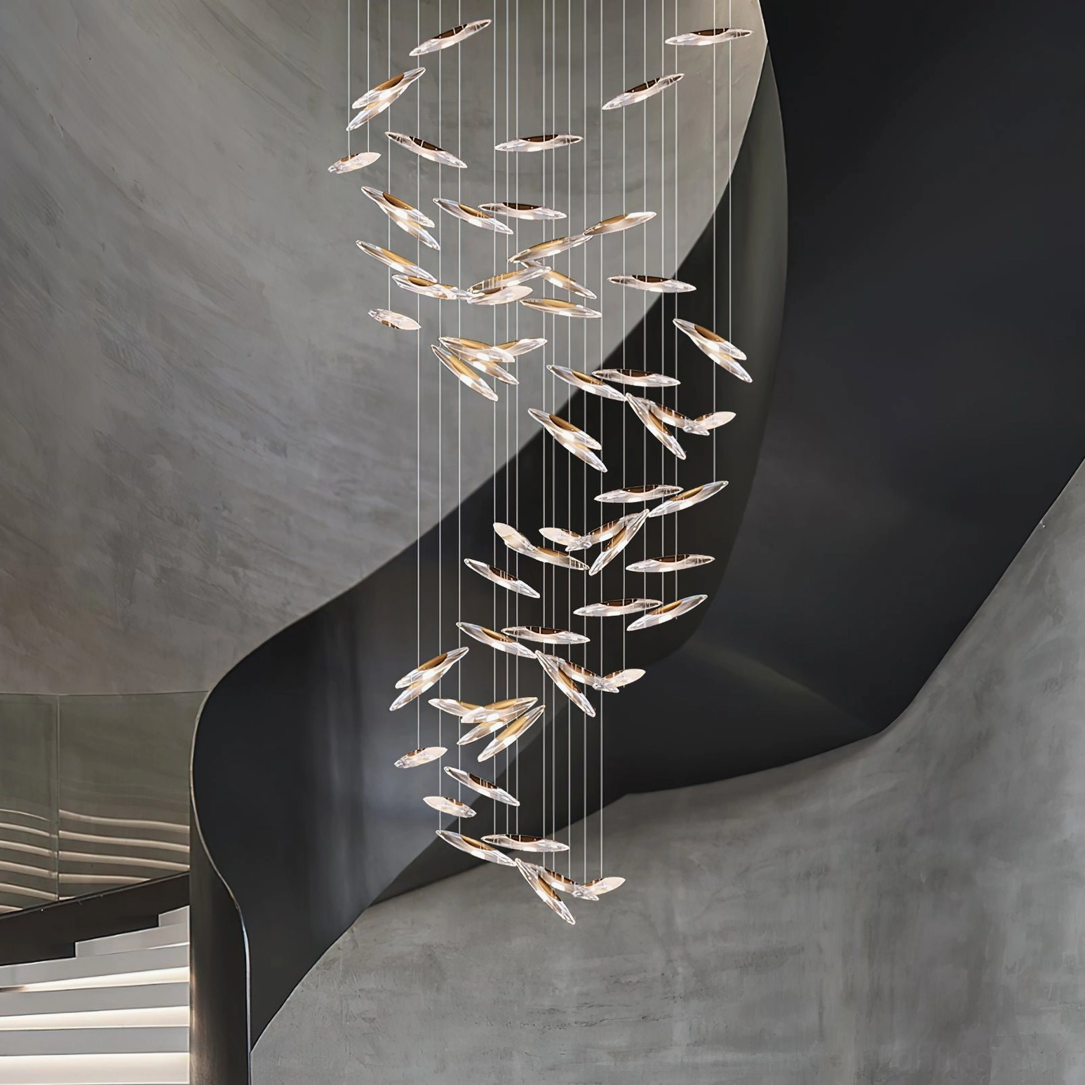 Modern chandelier with clear glass elements and suspended pendant design in minimalist setting