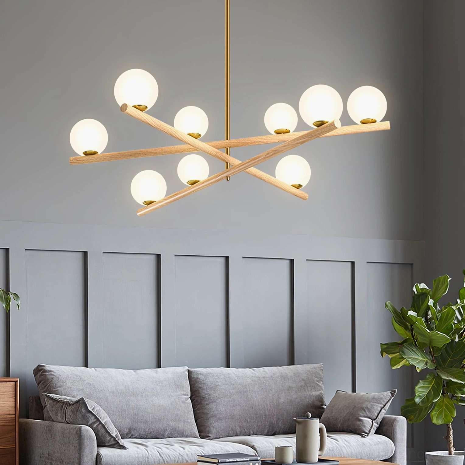 Line ball chandelier installed in contemporary living room, eye-level view showing frosted glass globes and wooden arm details with gold hardware