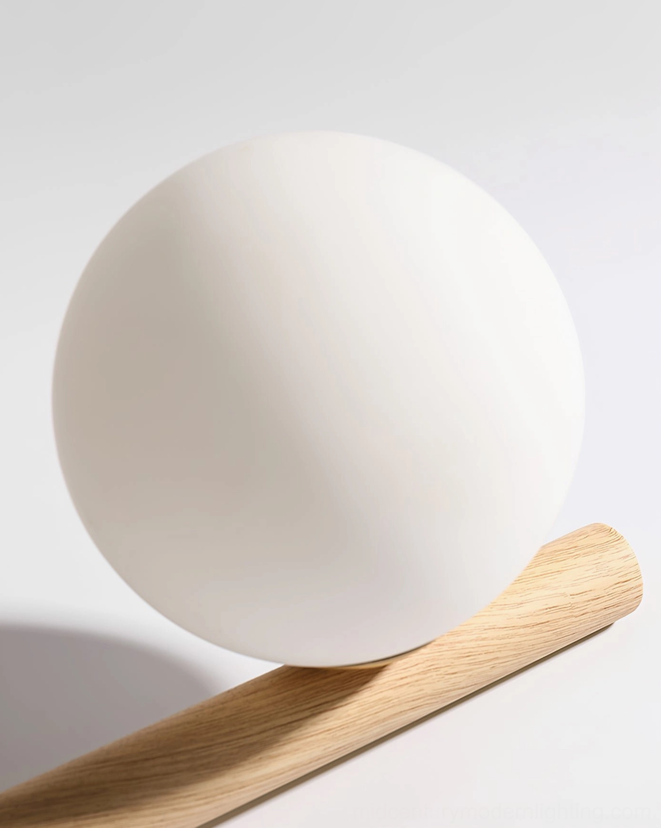 Line ball chandelier suspended in bright modern interior, demonstrating frosted opal glass light diffusion from multiple angles
