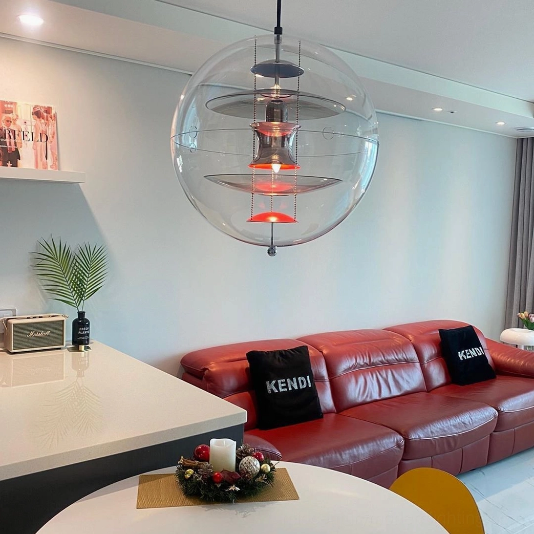 Transparent globe ceiling lamp with multi-color layered interior in open plan living space