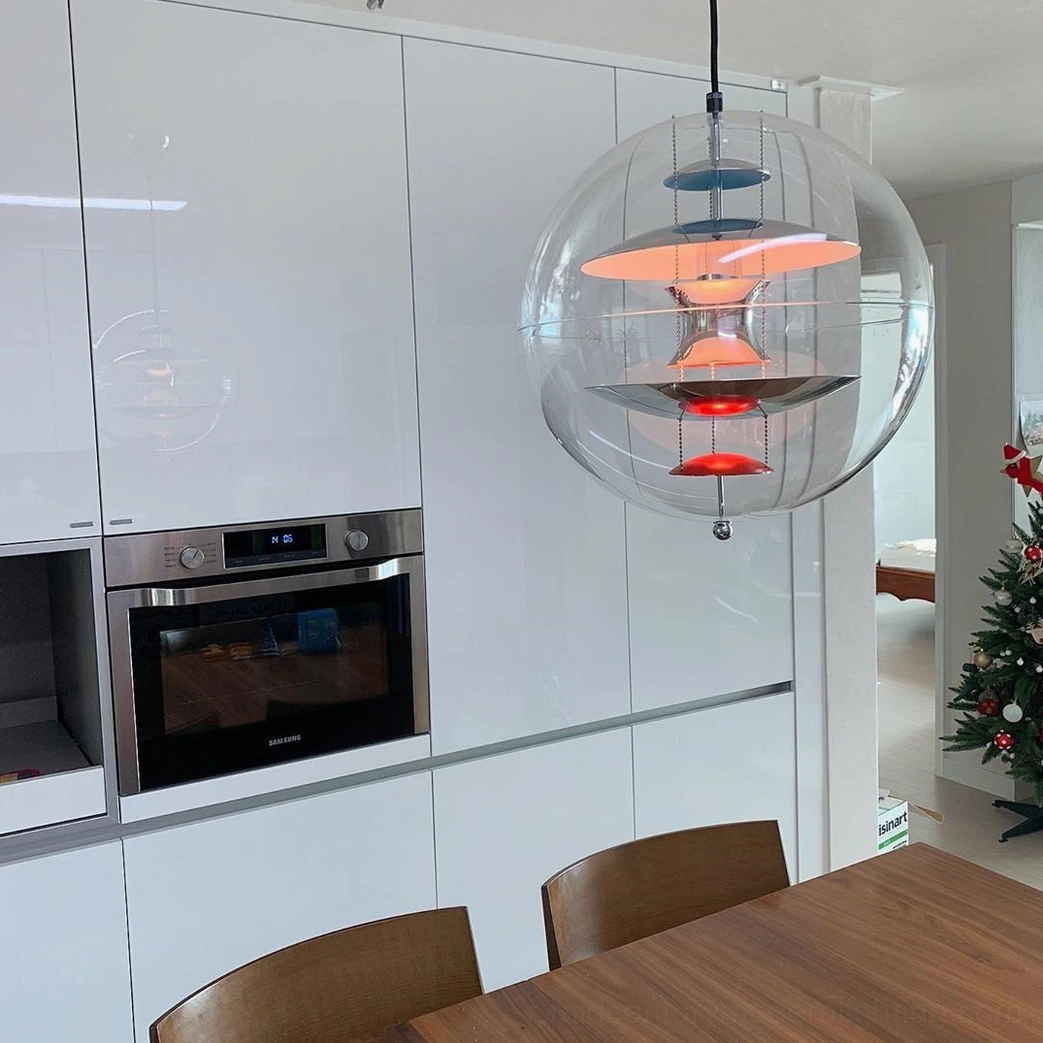 Modern globe suspension light showing geometric design and layered metal components