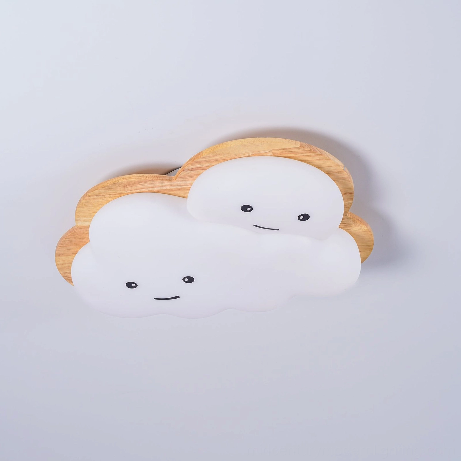 Modern kids ceiling lamp with happy cloud design mounted in playful children's room setting
