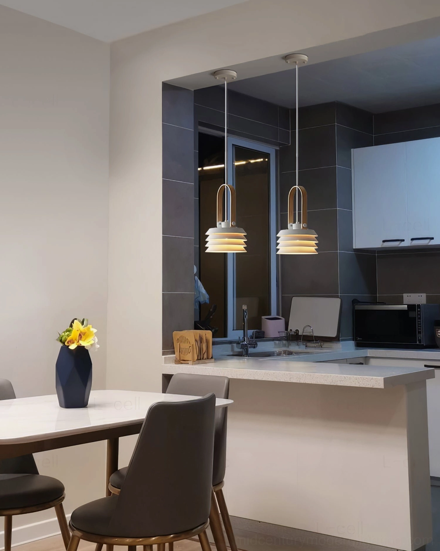 Two honeycomb pendant lamps illuminating modern kitchen and dining room open concept space