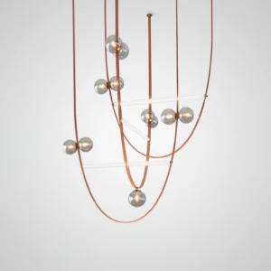 Overhead view of multi-strand modern leather pendant lighting fixture with curved brown leather cords and staggered glass orbs
