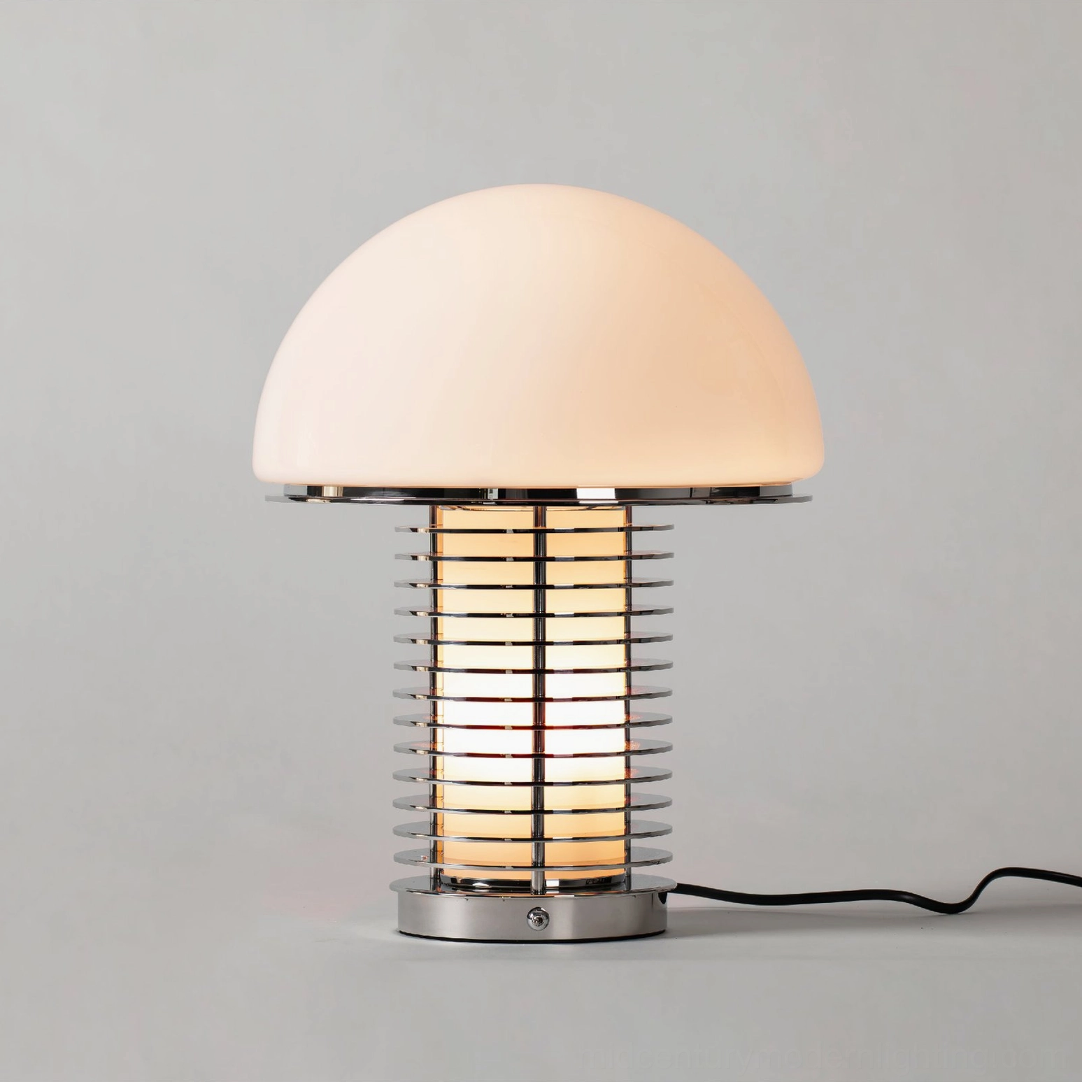 Modern mushroom dome lamp with polished chrome trim and exposed power cord, side front studio angle