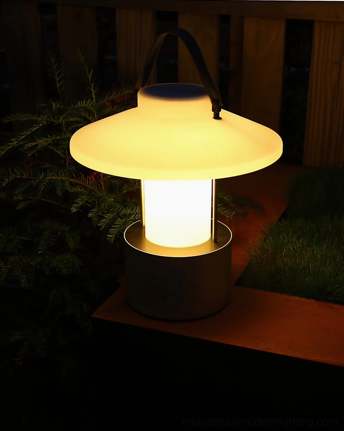 Modern minimalist outdoor table lamp in garden setting with contemporary styling