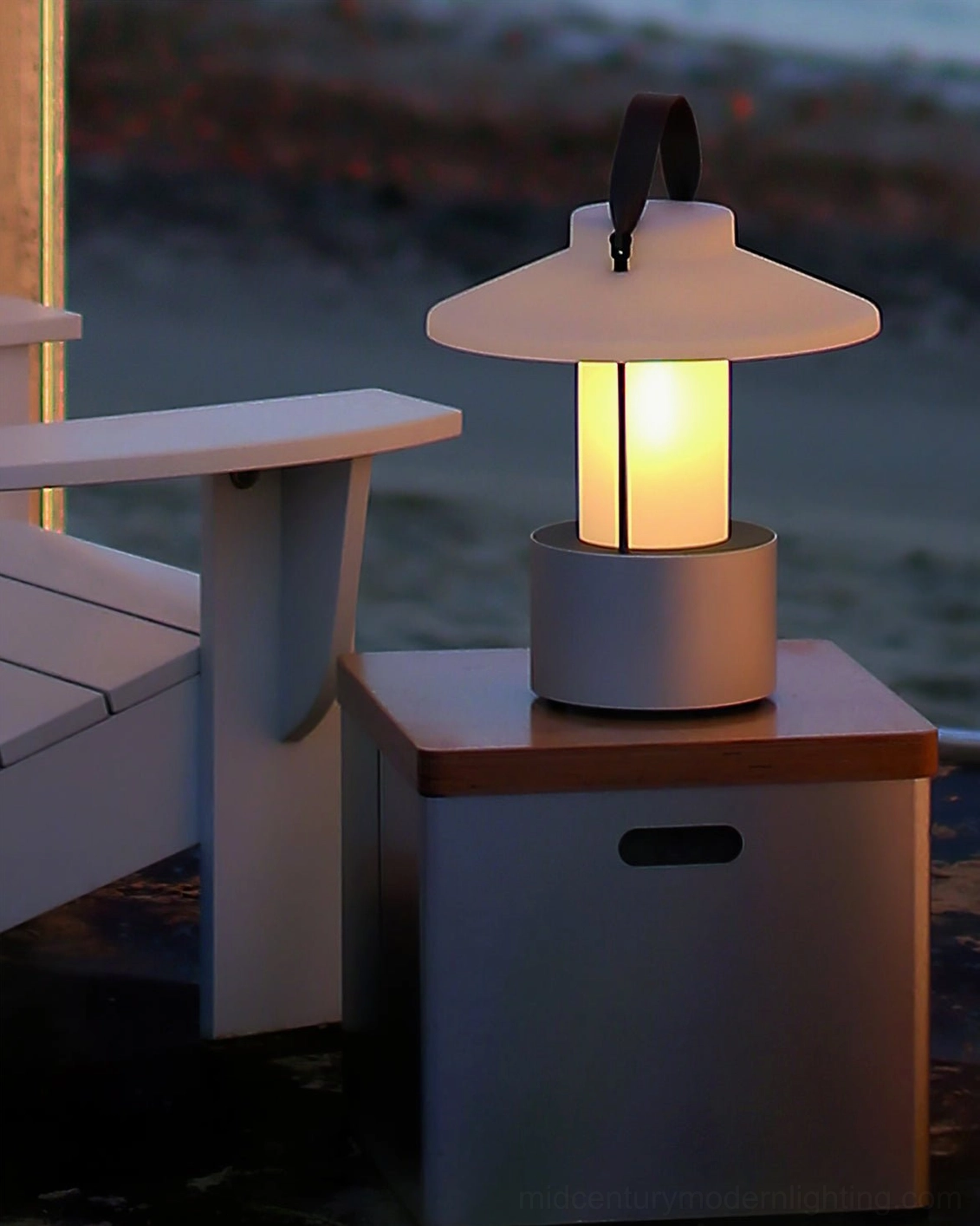 Minimalist outdoor patio lamp glowing warmly in nighttime lounge environment