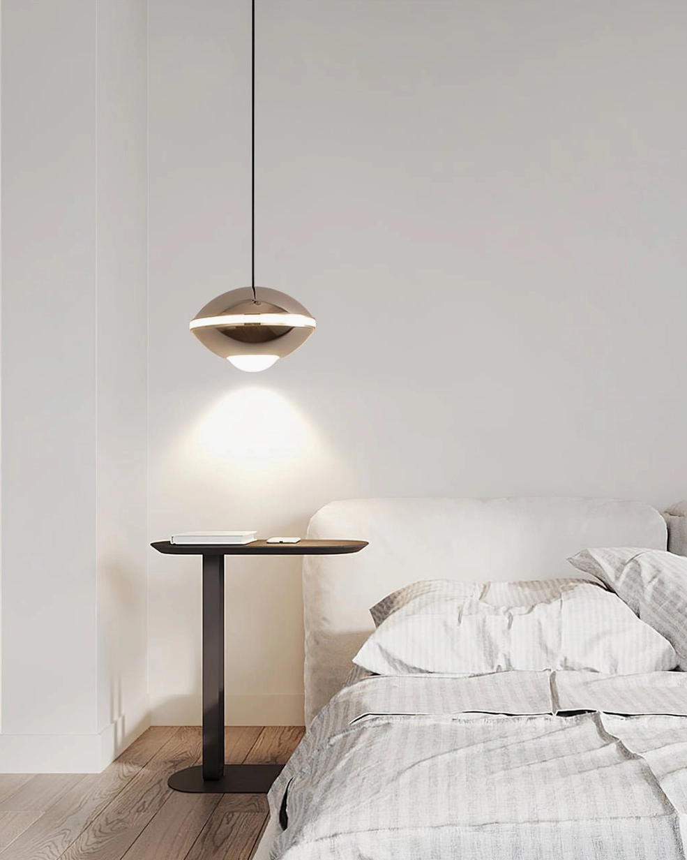 Modern pendant ceiling lamp in neutral bedroom with accent side table, two-tone metallic finish