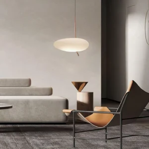 Modern pebbles pendant light installed in contemporary living room lounge area with off-white shade and warm copper fixtures