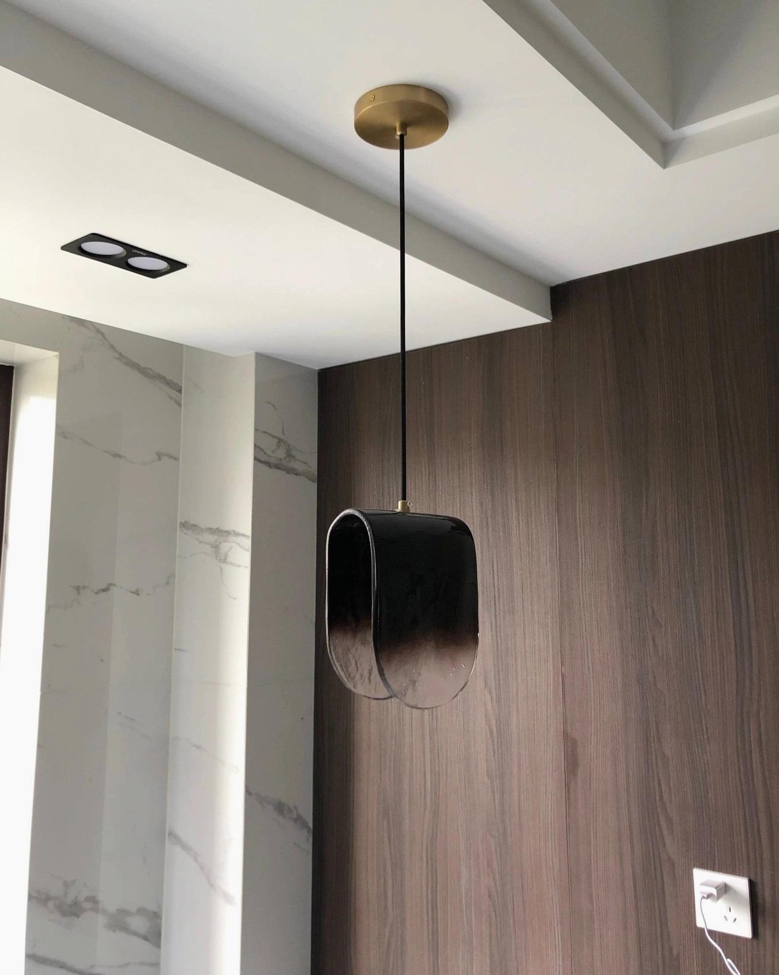 Modern pendant fixture highlighting textured glass surface and professional ceiling installation