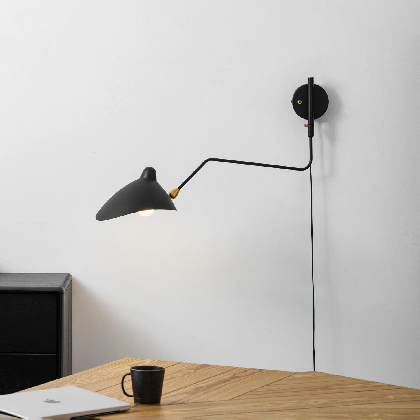 Modern spider-inspired wall sconce with multiple swiveling brass-jointed arms