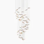 Modern spiral glass chandelier with cascading clear pendants and minimalist luxury design on white studio background