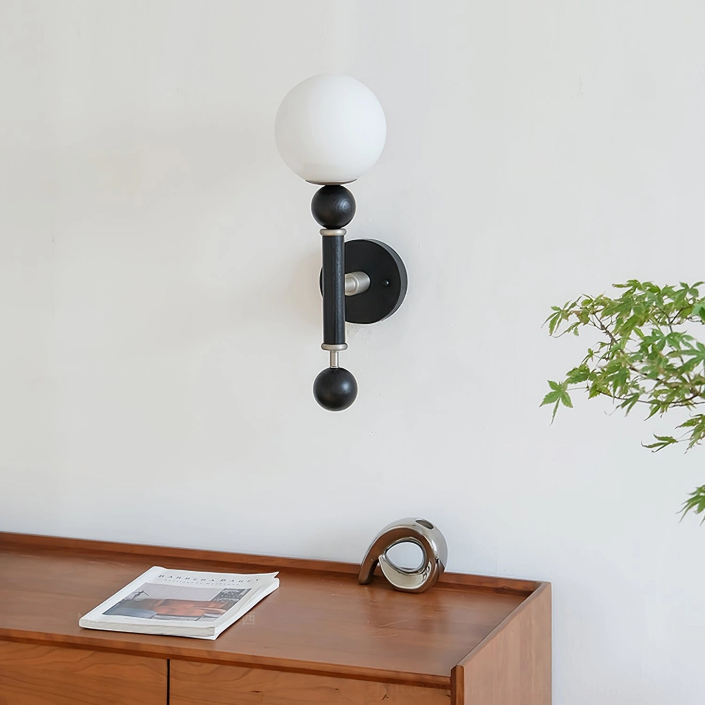 Compact minimalist globe wall sconce on console table with coordinated color palette and interior styling
