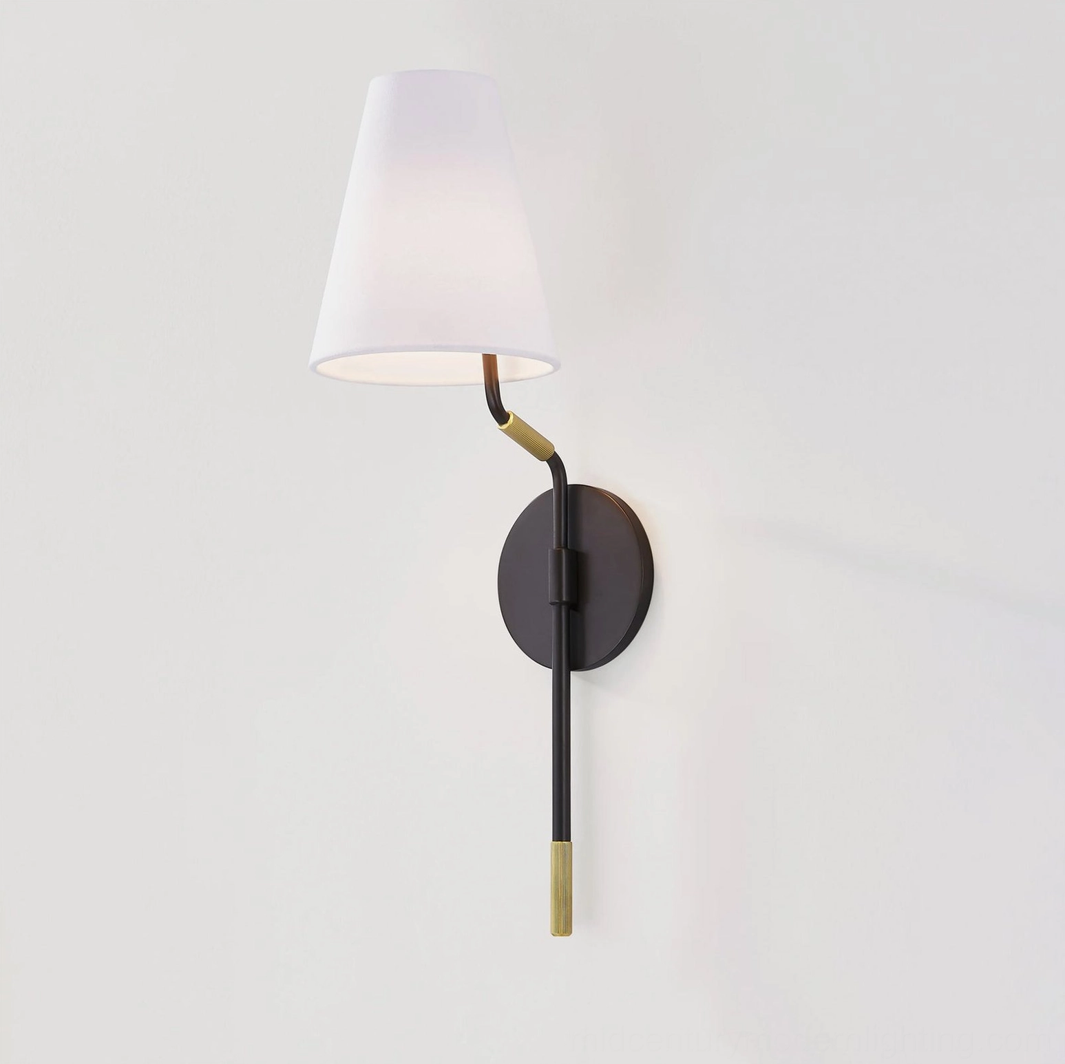 Illuminated modern wall sconce with black metal hardware and glowing fabric shade, three-quarter residential setting