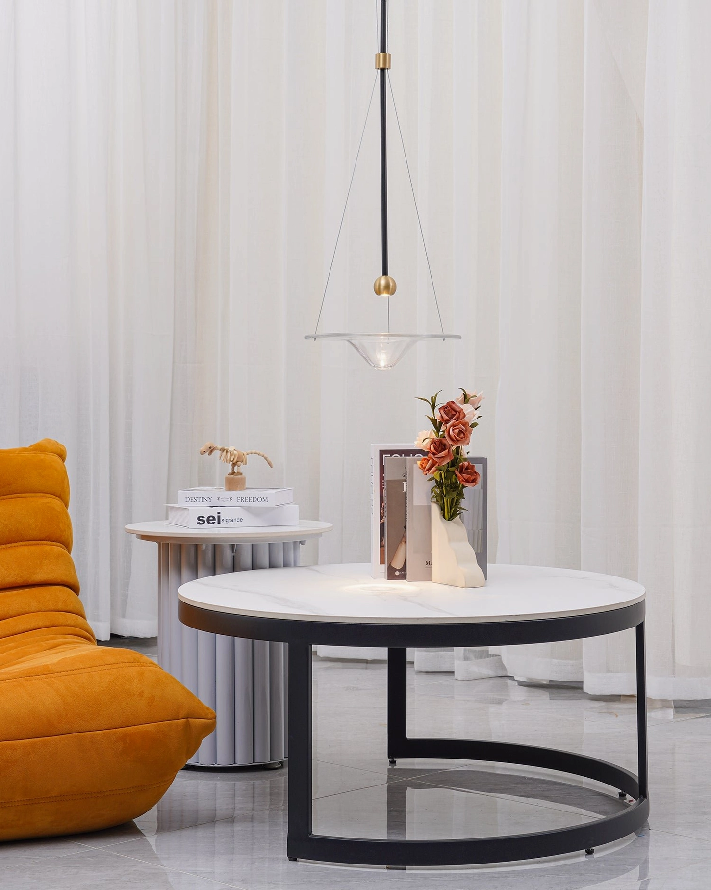 Momento glass pendant light close-up highlighting brushed gold finish and transparent glass sphere