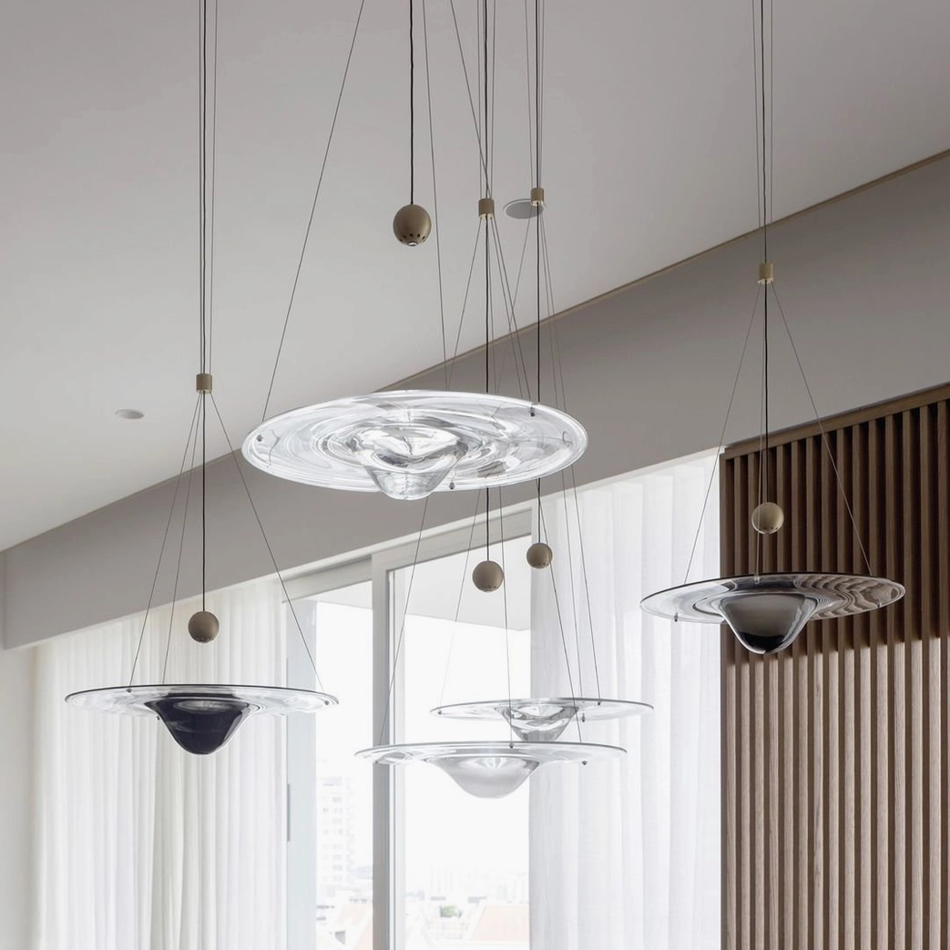 Mixed Momento pendant lamps in bright modern residential interior with Nordic minimalist style and spherical metal accents