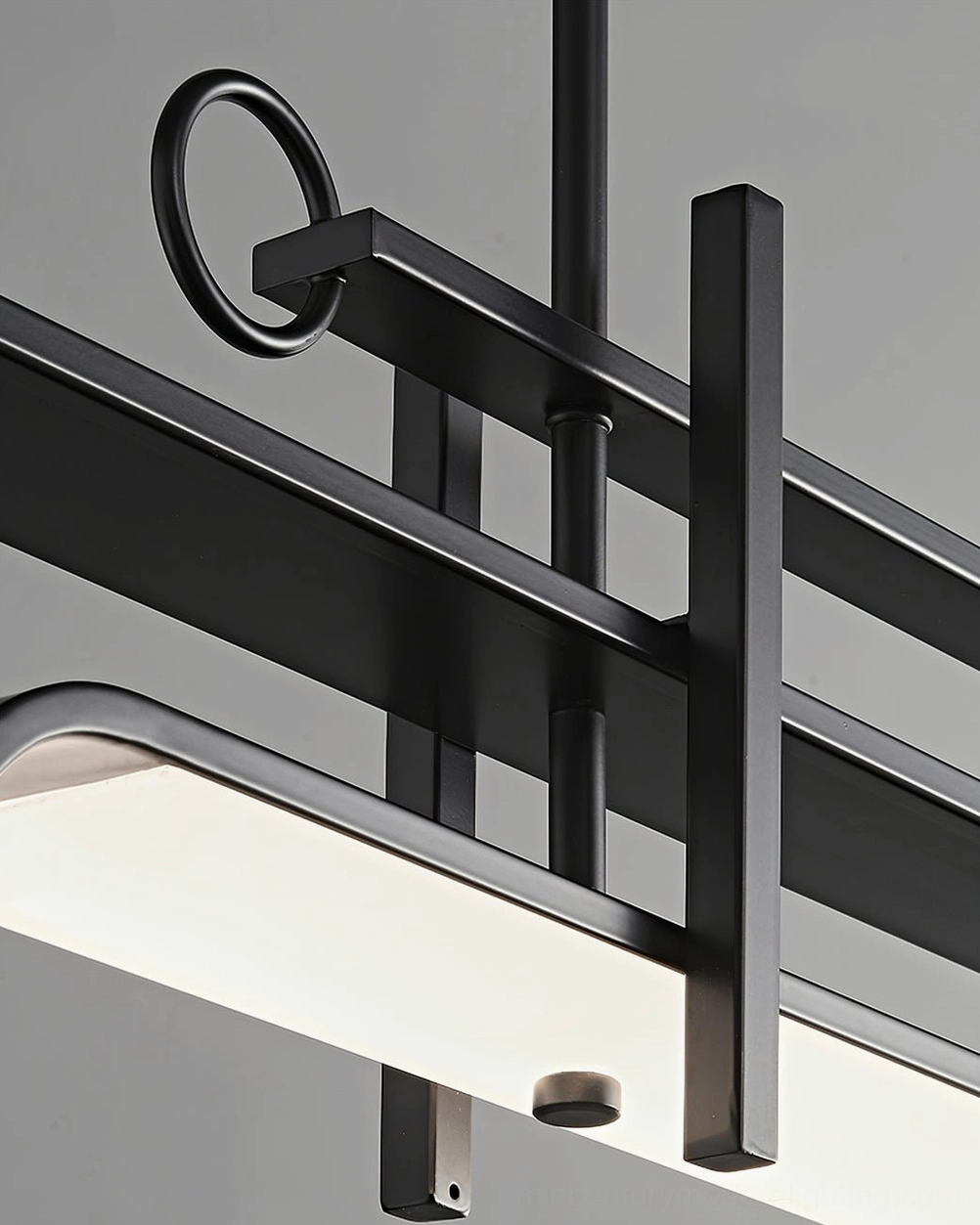 Close-up detail of matte black brass frame and frosted acrylic diffuser of modern linear chandelier