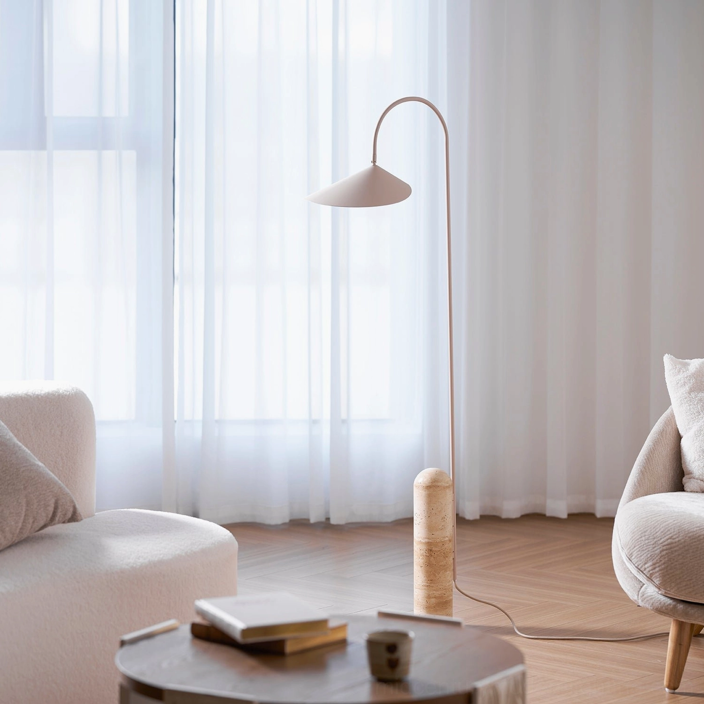 Mono floor lamp angle perspective showing sculptural metal curve and stone base proportions