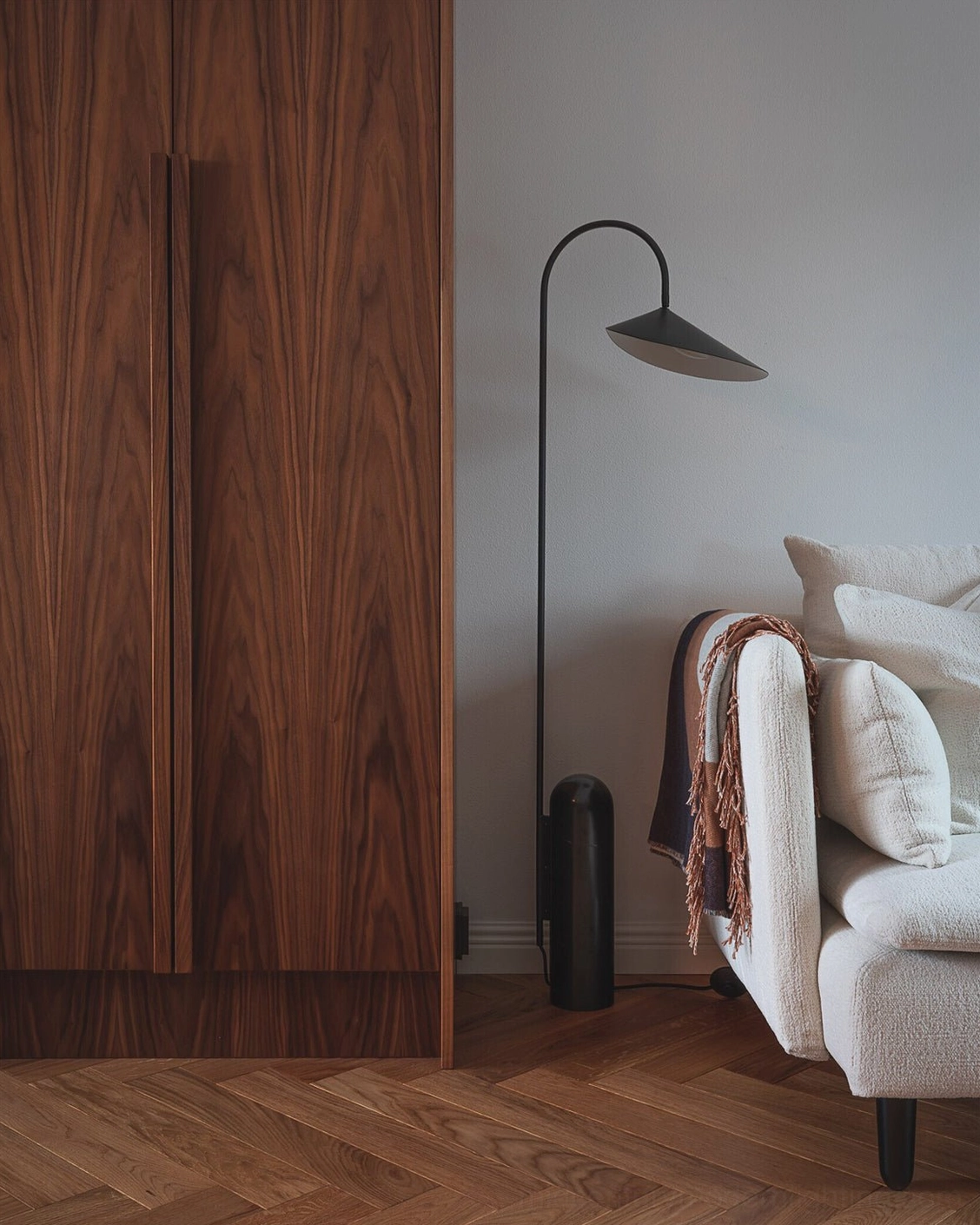 Mono floor lamp base detail showing stone grain and cylindrical form engineering