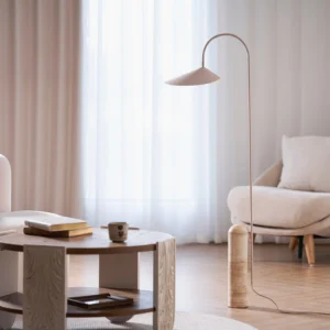 Mono floor lamp in beige finish positioned in modern Nordic living room beside coffee table and sofa, ambient lighting