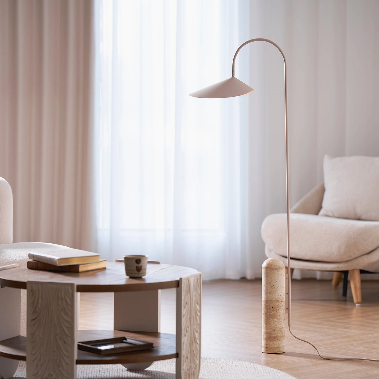 Mono floor lamp in beige finish positioned in modern Nordic living room beside coffee table and sofa, ambient lighting