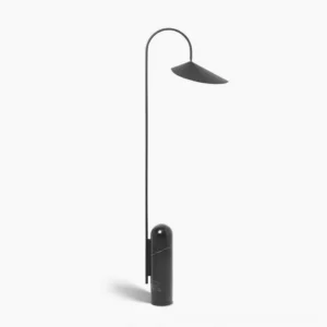 Mono floor lamp with black matte metal curved arc and black cavestone base on white background, minimalist sculptural design