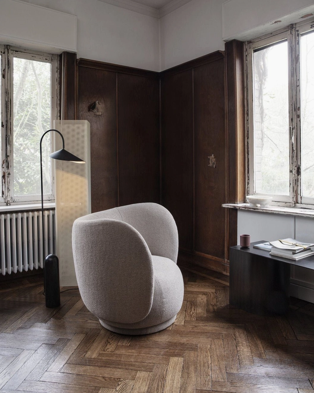 Mono floor lamp in living area showing curved arm flexibility and light direction capability