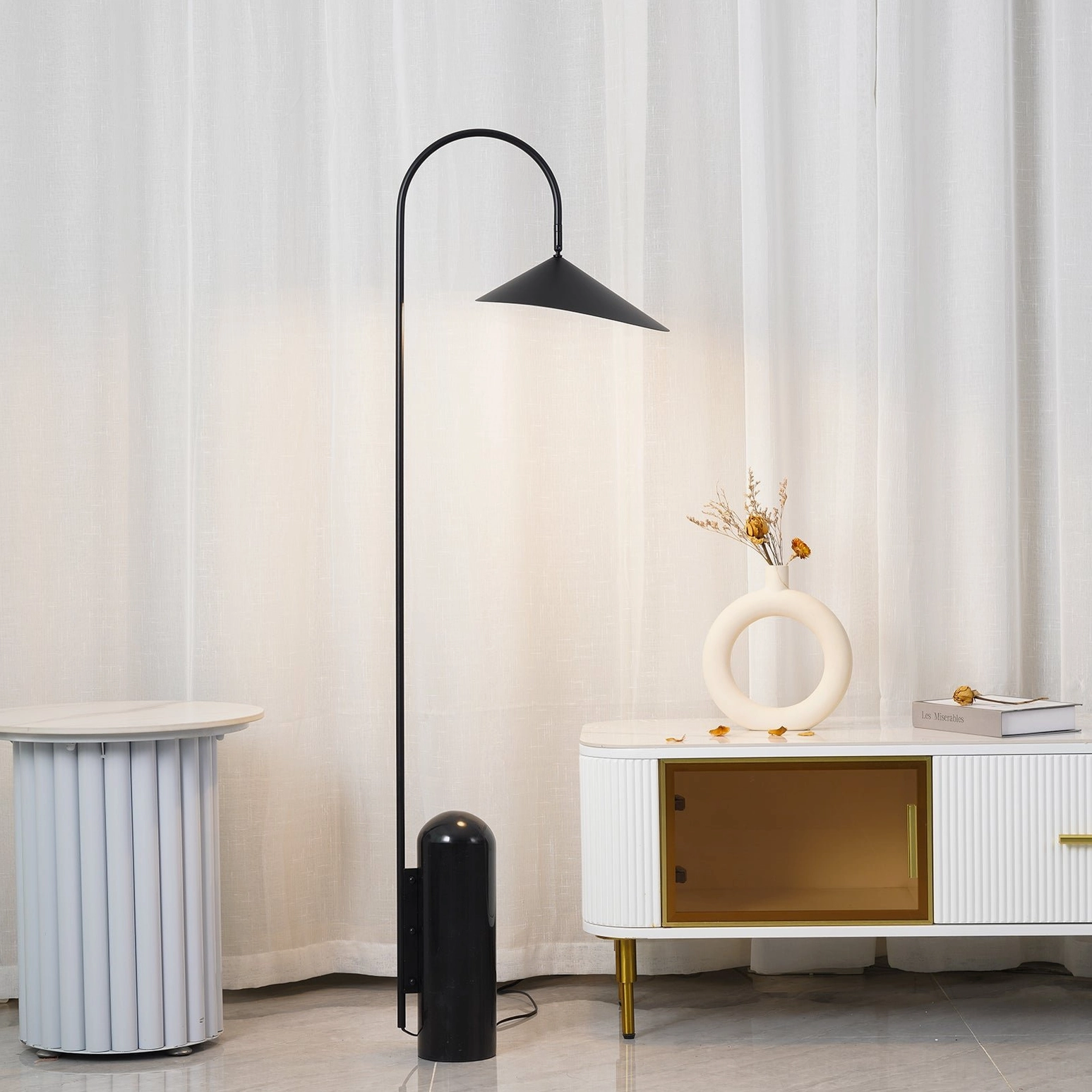 Mono floor lamp in neutral interior with warm lighting and minimal furnishings