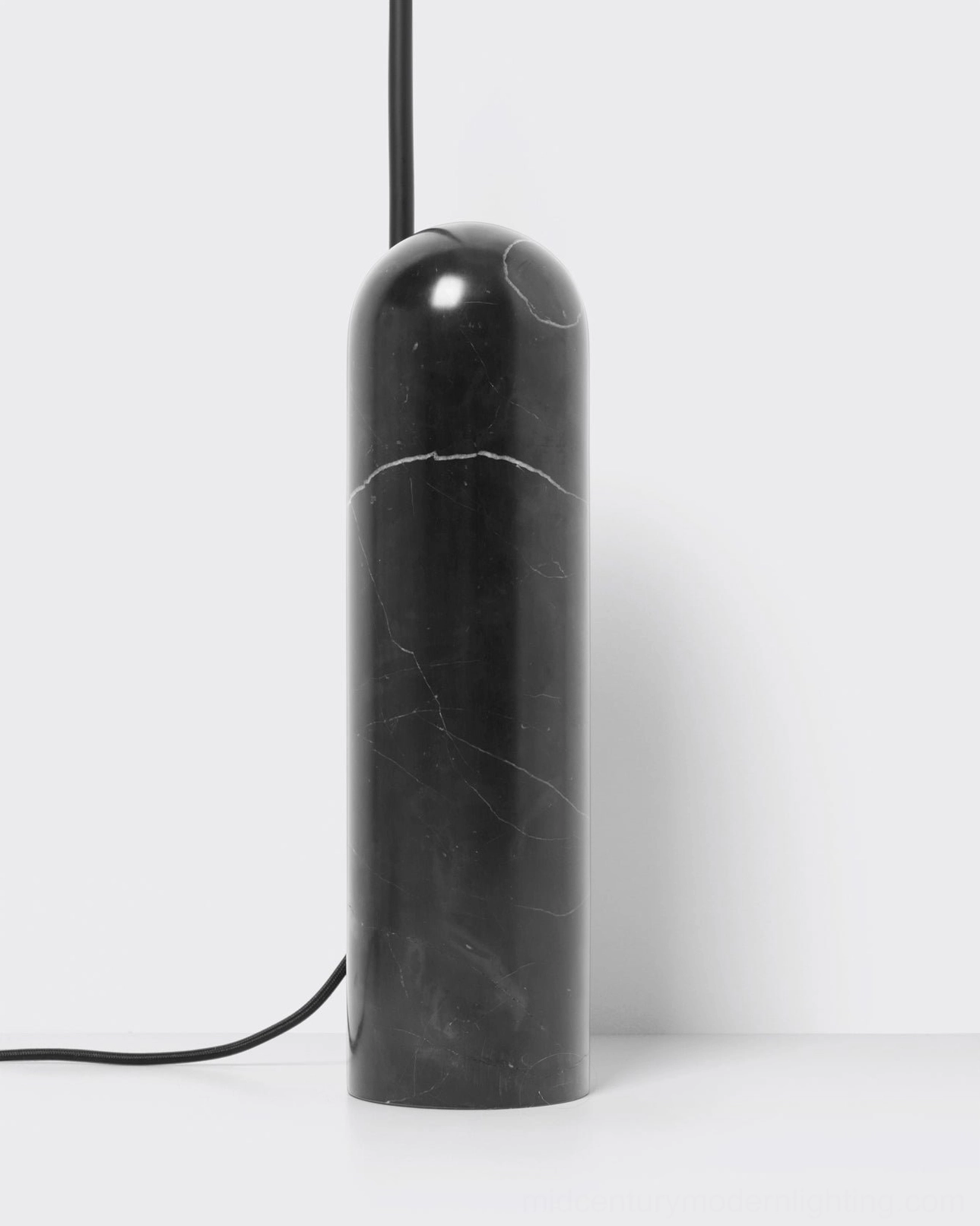 Mono floor lamp positioned in reading corner providing directional task lighting