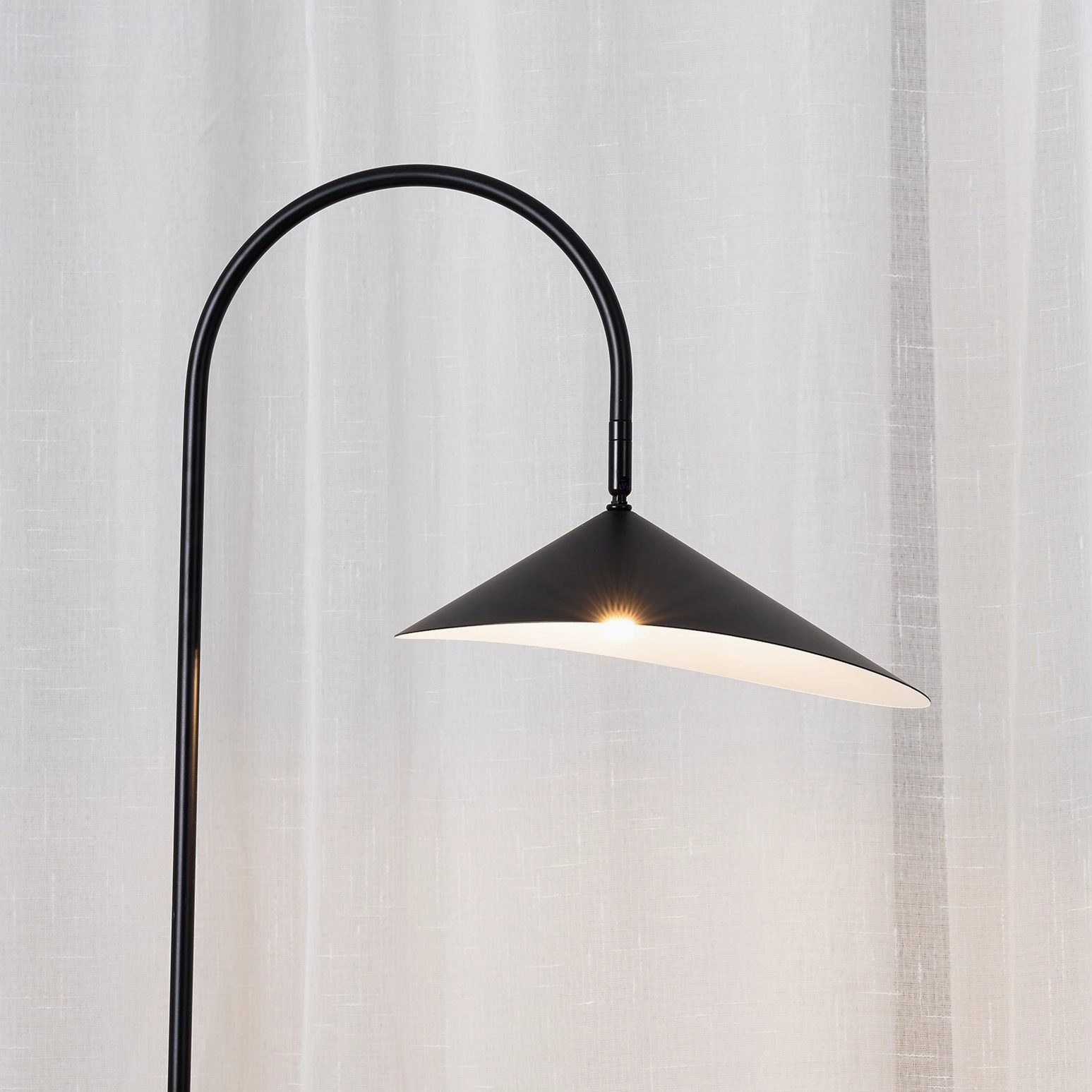 Mono floor lamp sculptural metal arc design with natural cavestone pedestal